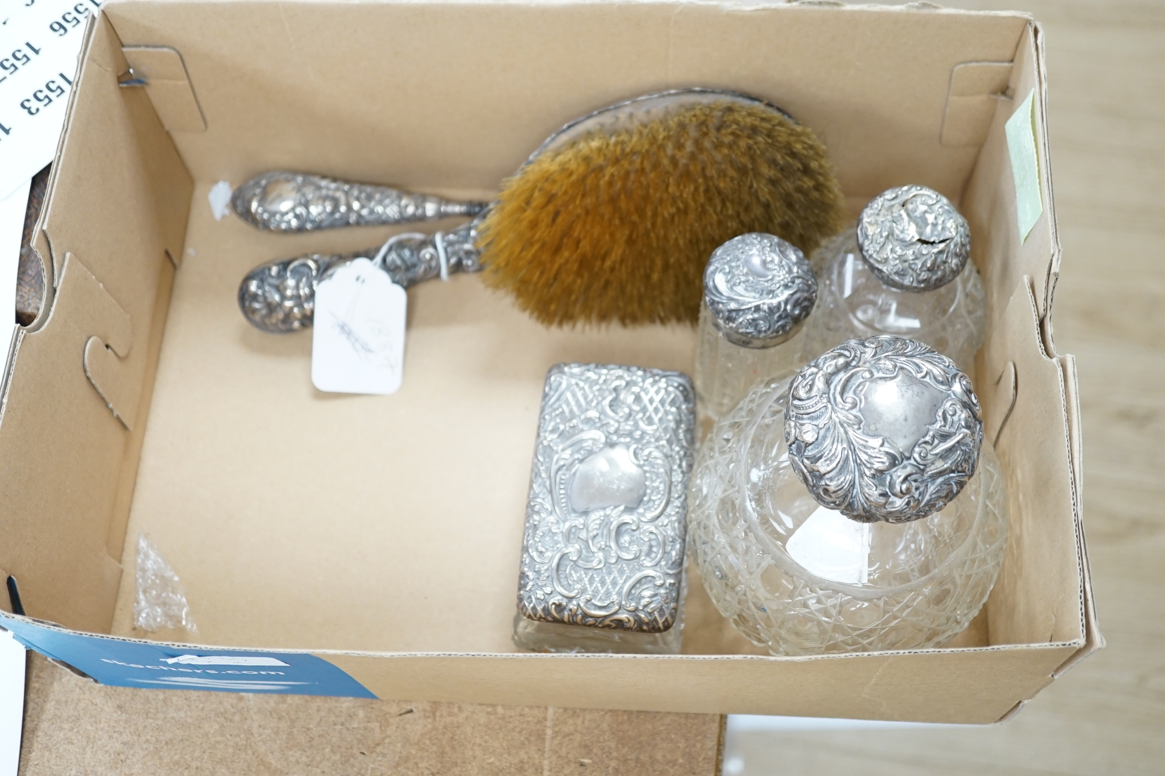 An Edwardian silver mounted cut glass scent bottle, Birmingham, 1902, seven other silver mounted dressing table items and four other items.